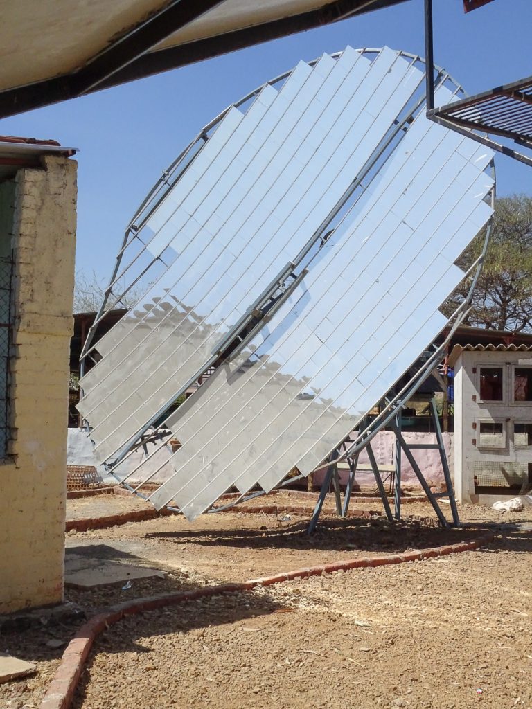 photograph of a large solar reflector disc on display at the Technology Demonstration Park, Vigyan Ashram, India